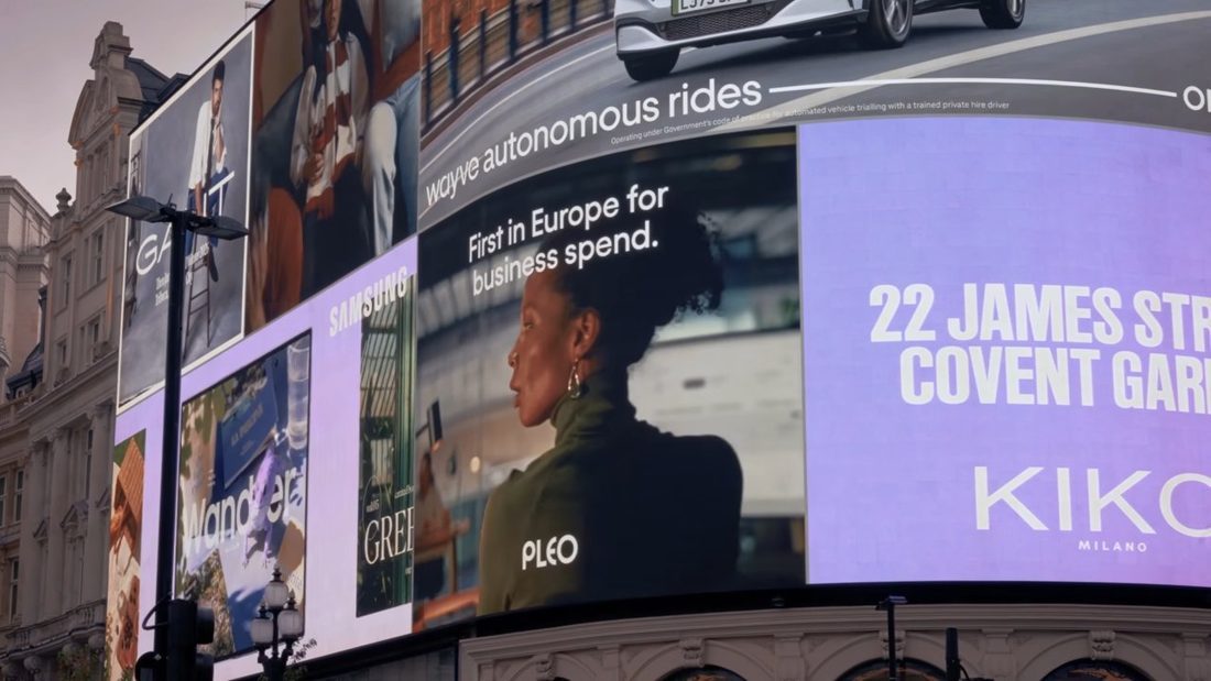Pleo billboard at Piccadilly Circus, London, with a giant close-up eye and the line For those who can see around corners.
